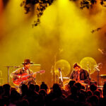 Two musicians perform on stage